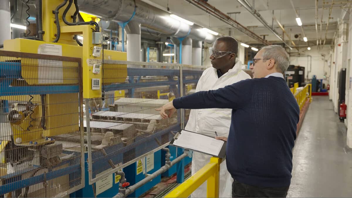 Man being show around a factory