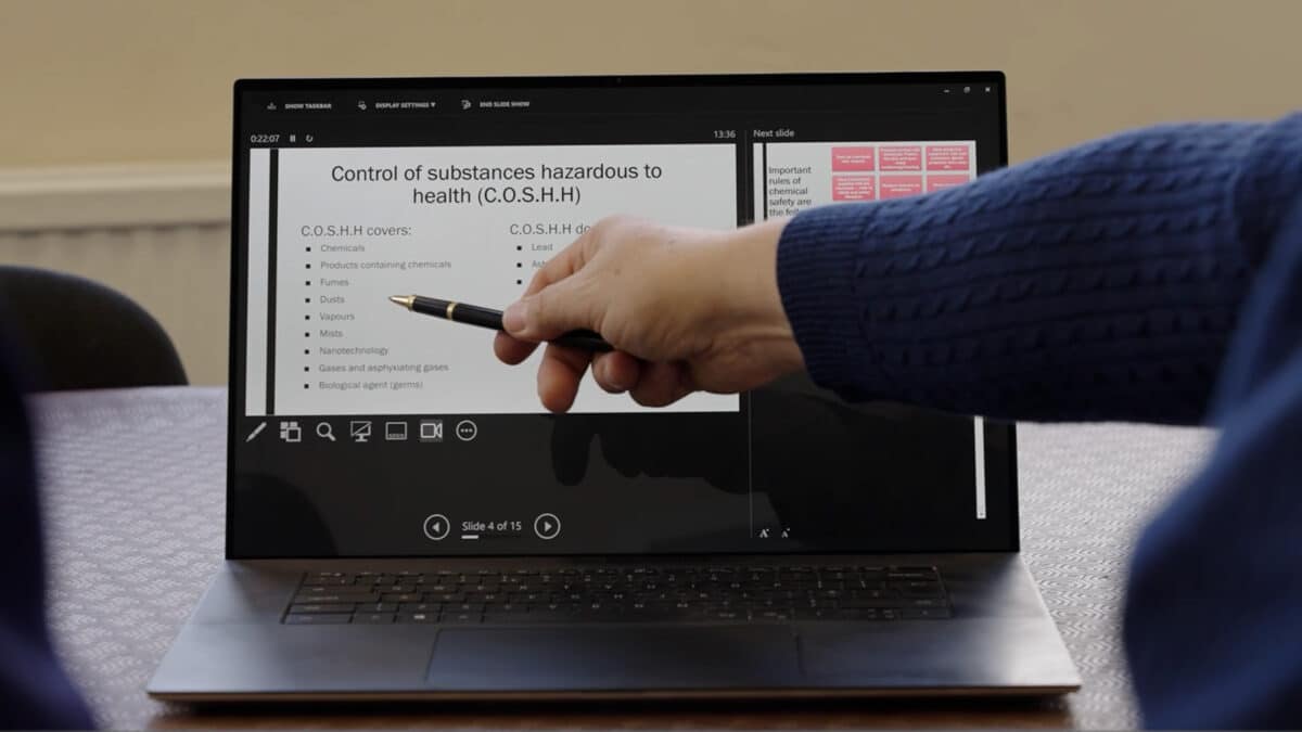 Man pointing at screen during training video production.