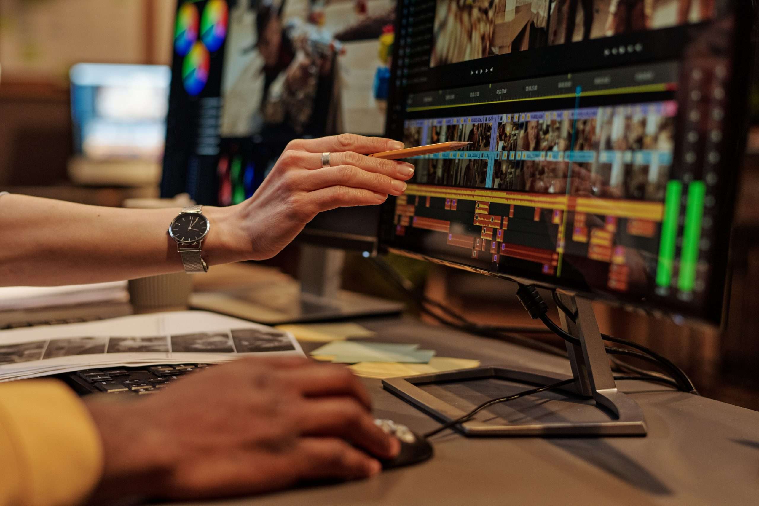 Editor and producer working on an edit together in Premiere.