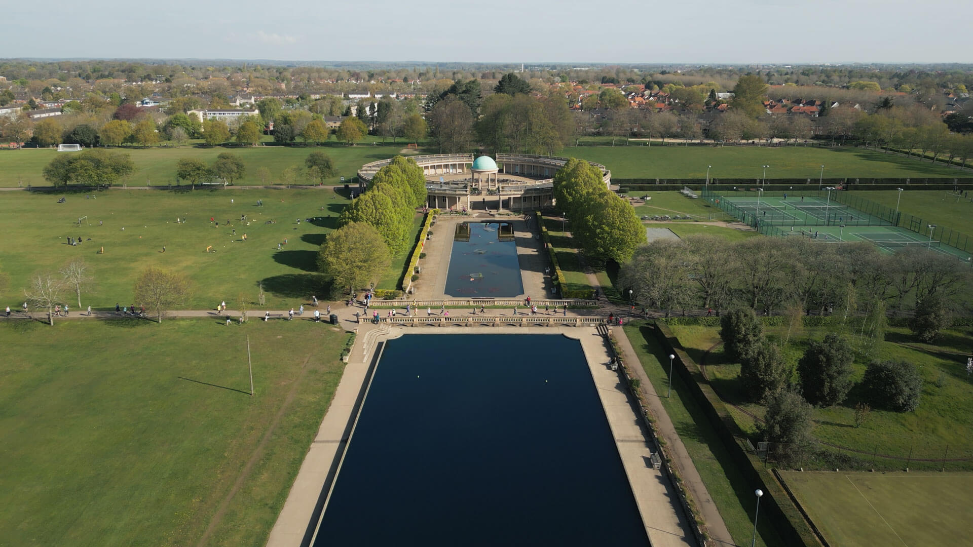 Ariel shot of Norwich Park on a sunny day with runners on the ground.